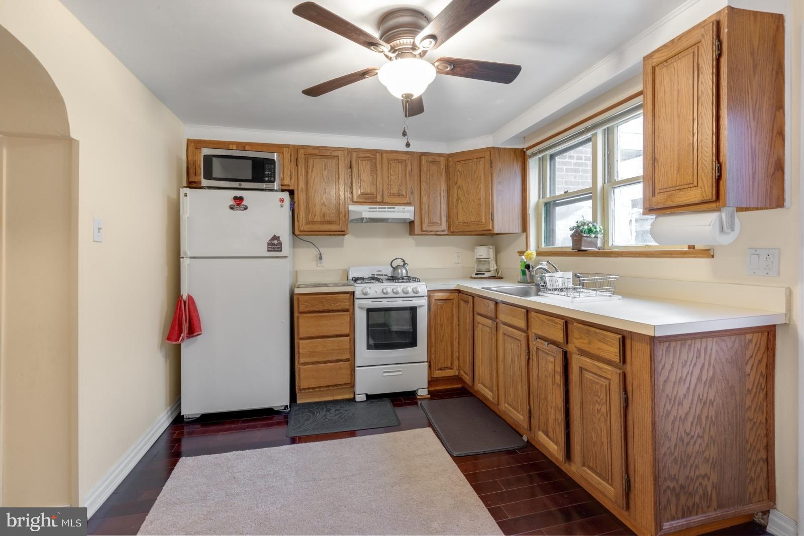 1006 Morris Street Philadelphia, PA 19148 - Photo 9 of 24 a kitchen with stainless steel appliances kitchen island a refrigerator sink and cabinets