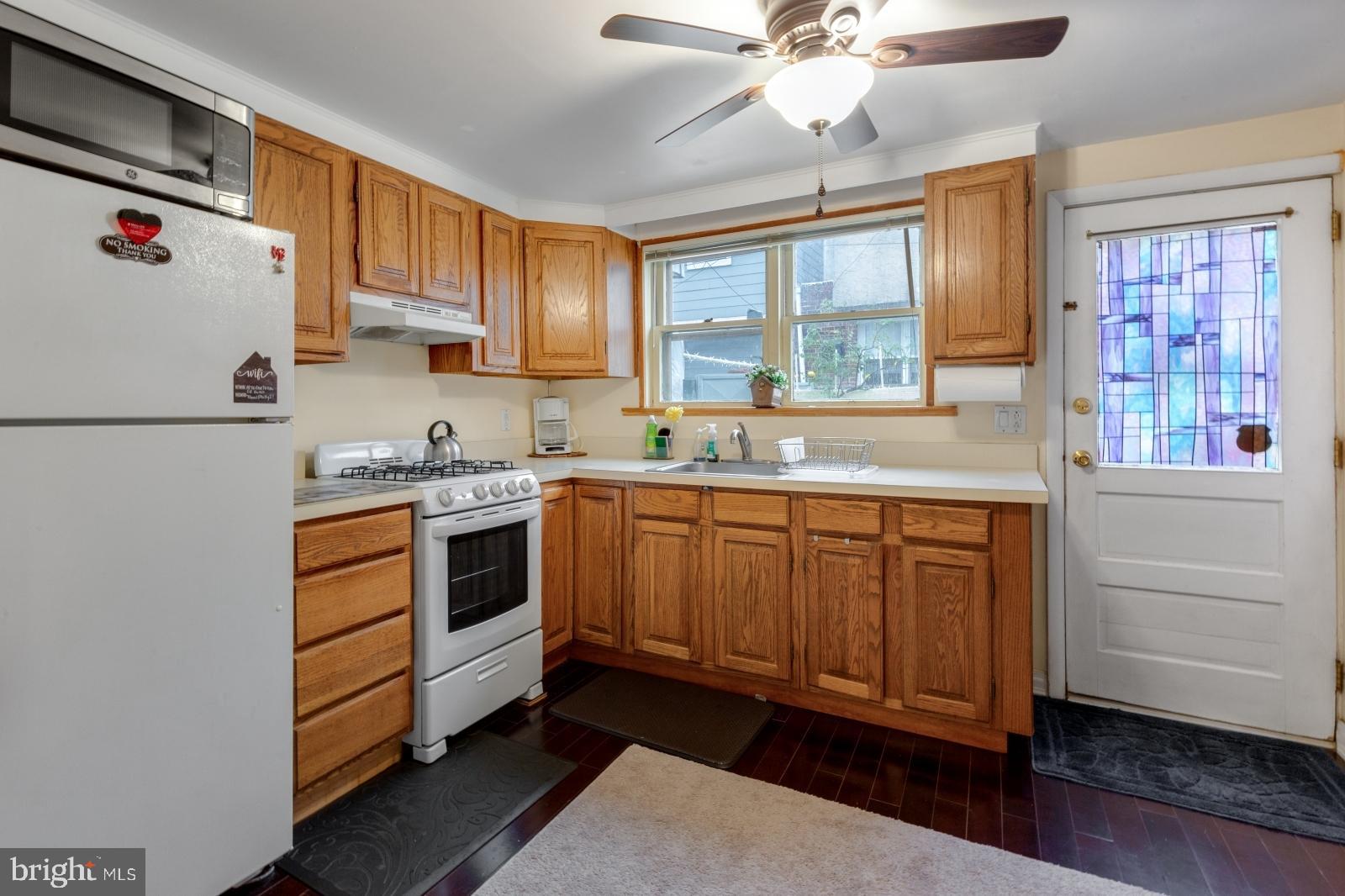 1006 Morris Street Philadelphia, PA 19148 - Photo 10 of 24 a kitchen with stainless steel appliances granite countertop a refrigerator and a sink