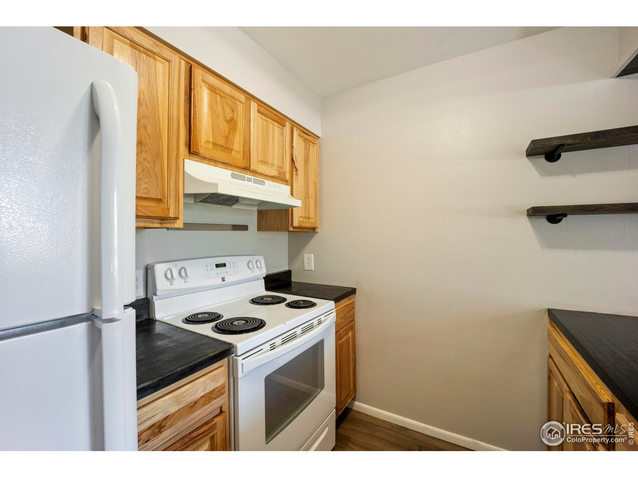 3431 Stover Street, Unit 513 Fort Collins, CO 80525 - Photo 11 of 28 a kitchen with a stove cabinets and a refrigerator