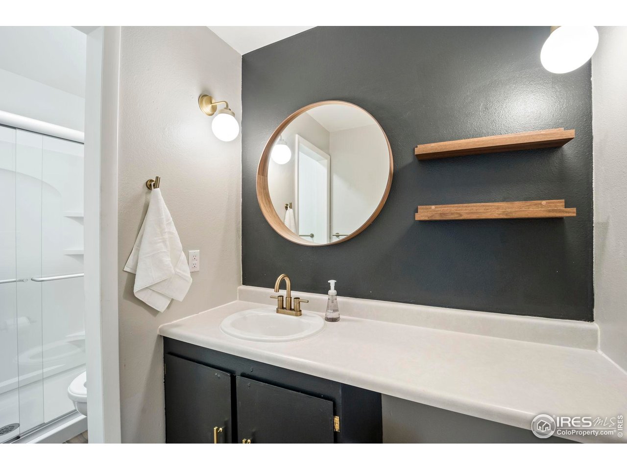 3431 Stover Street, Unit 513 Fort Collins, CO 80525 - Photo 14 of 28 a bathroom with a sink and a mirror