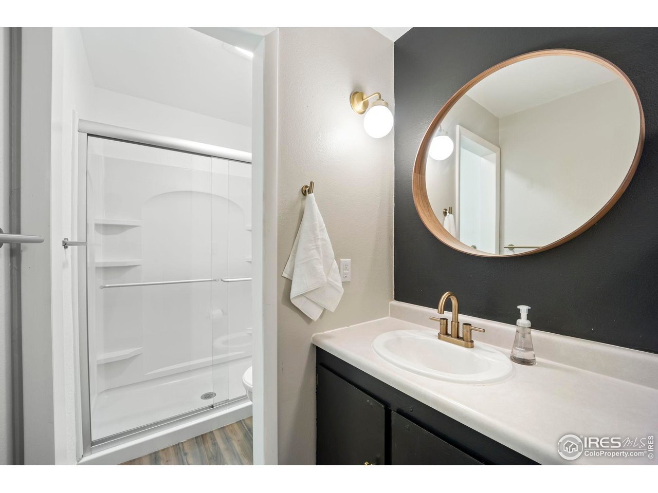 3431 Stover Street, Unit 513 Fort Collins, CO 80525 - Photo 15 of 28 a bathroom with a sink mirror and vanity