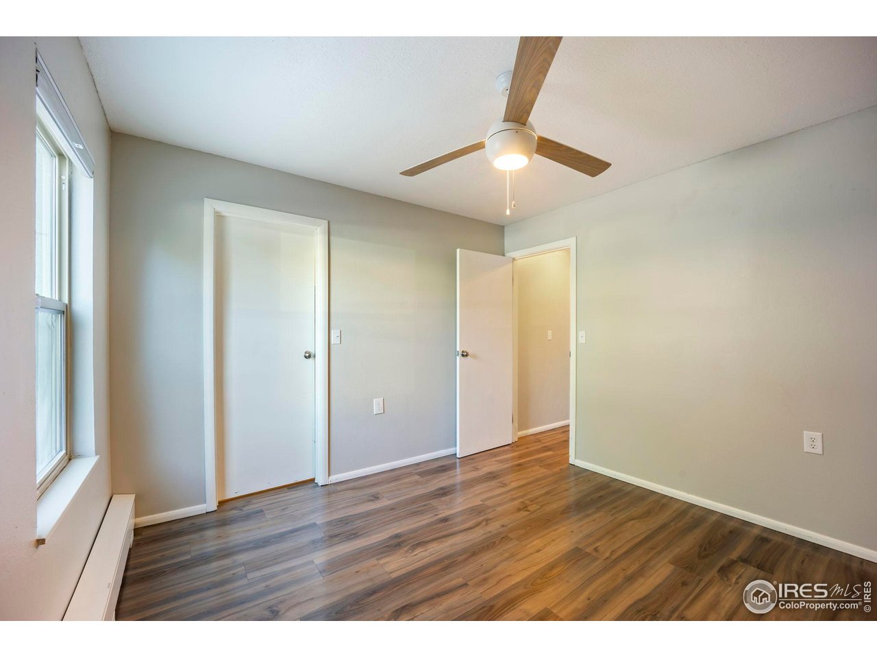 3431 Stover Street, Unit 513 Fort Collins, CO 80525 - Photo 16 of 28 an empty room with wooden floor and windows