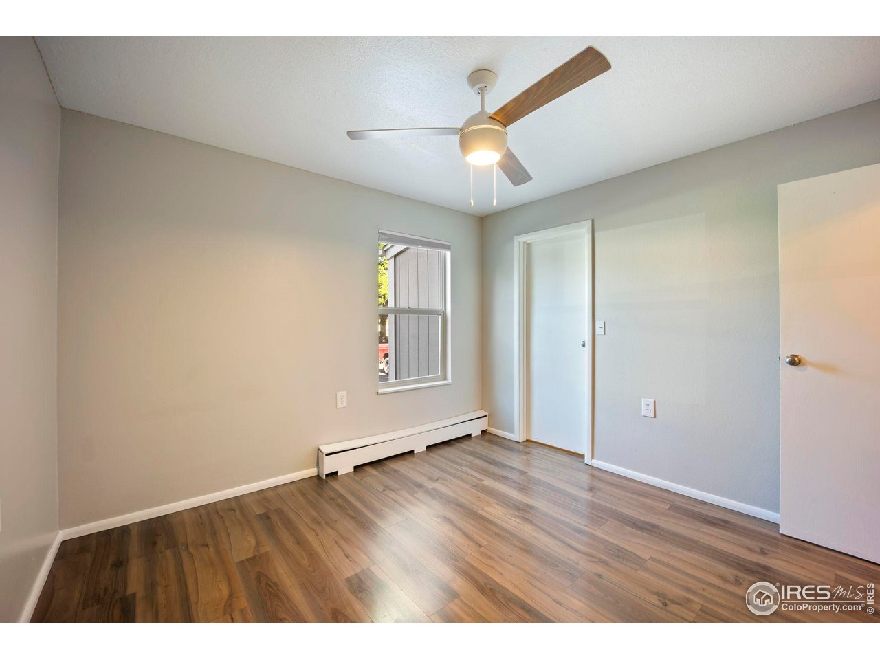3431 Stover Street, Unit 513 Fort Collins, CO 80525 - Photo 18 of 28 an empty room with wooden floor and windows