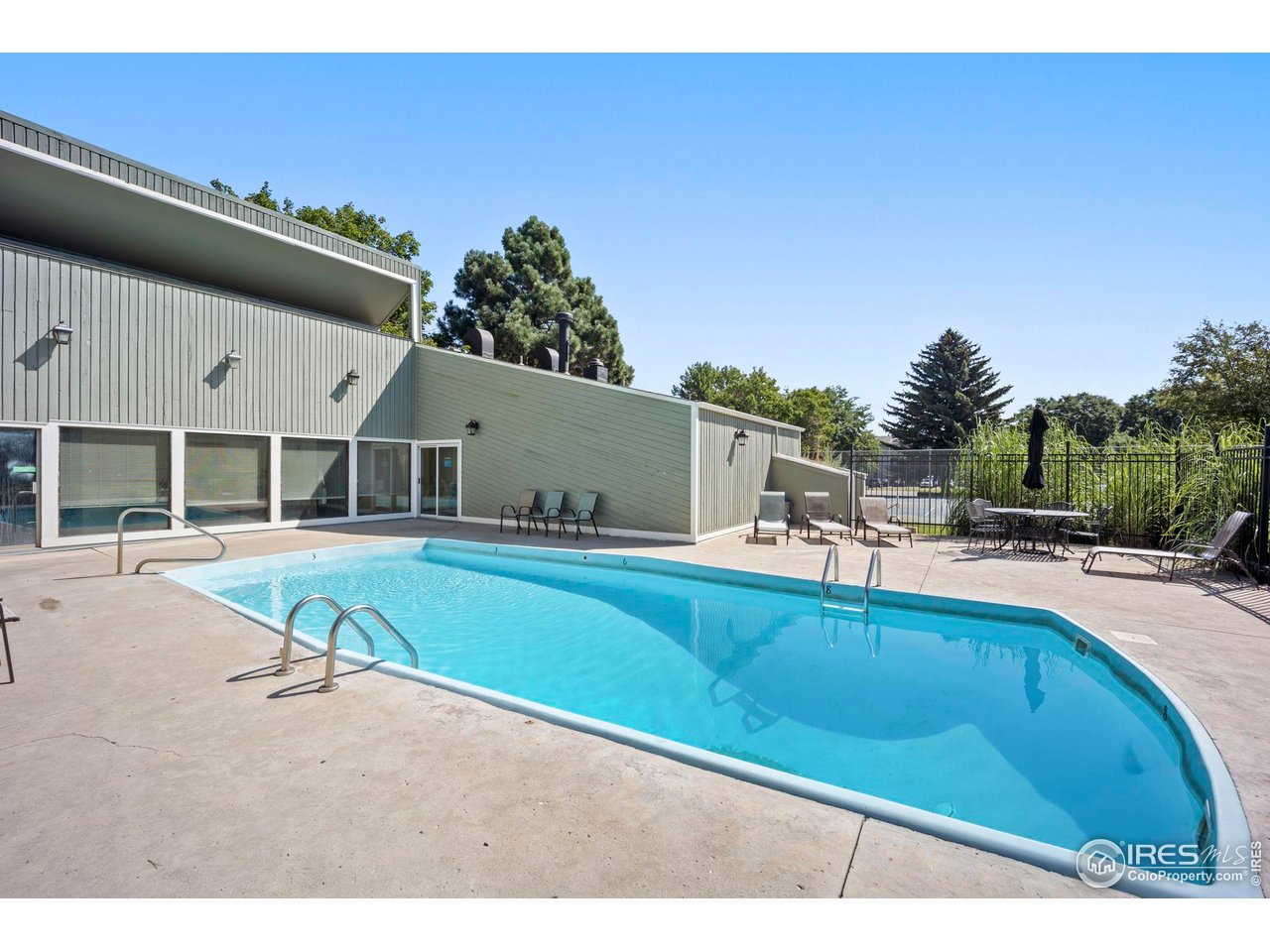 3431 Stover Street, Unit 513 Fort Collins, CO 80525 - Photo 22 of 28 a swimming pool with outdoor seating and yard