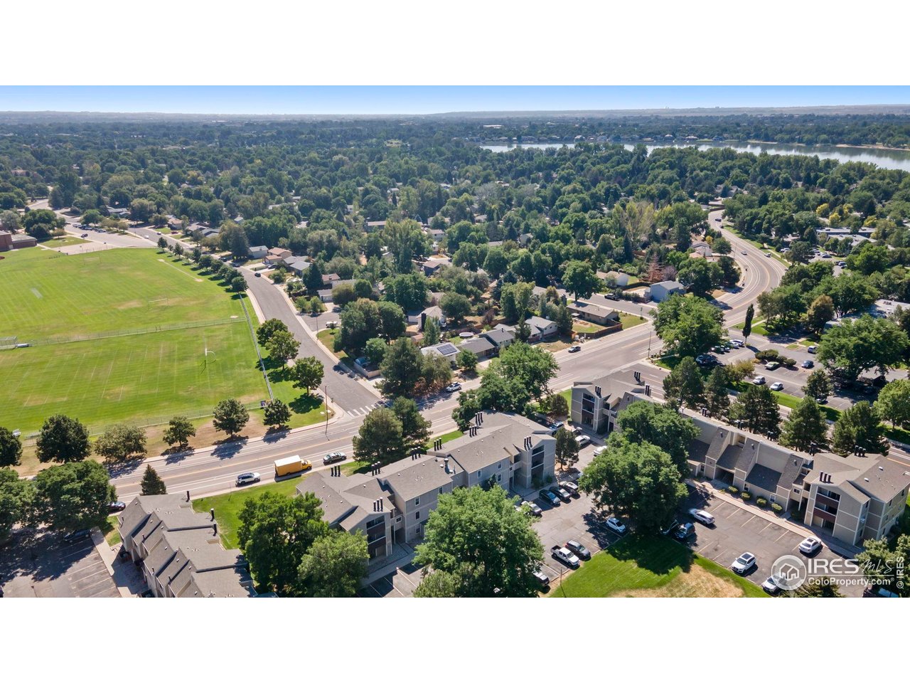 3431 Stover Street, Unit 513 Fort Collins, CO 80525 - Photo 27 of 28 an aerial view of residential building and lake