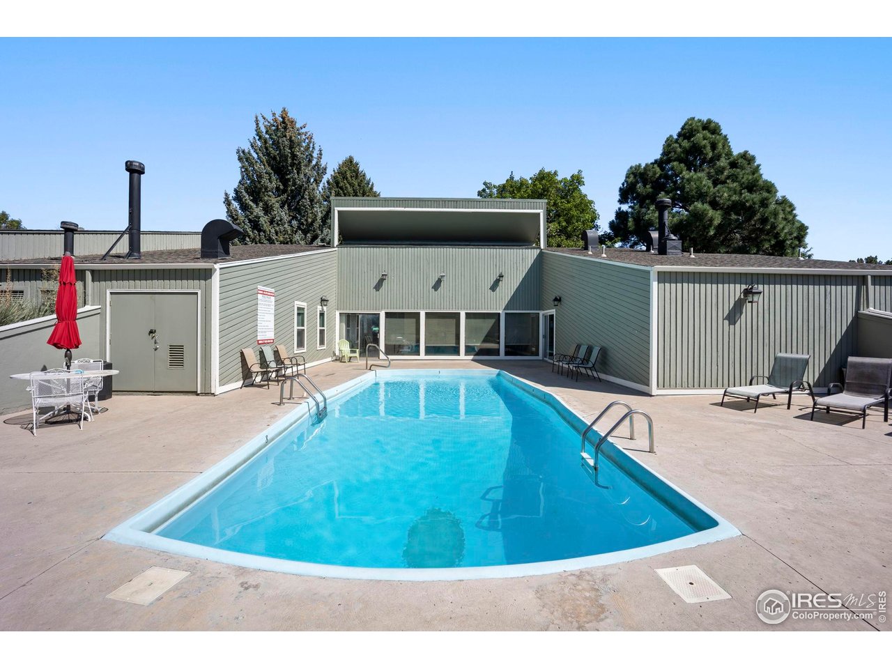 3431 Stover Street, Unit 513 Fort Collins, CO 80525 - Photo 5 of 28 a view of a swimming pool with a lounge chairs