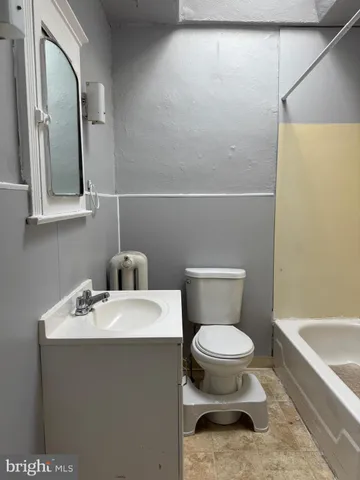 a bathroom with a sink a toilet and bathtub