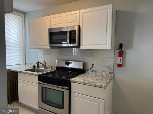 a kitchen with a stove and a microwave
