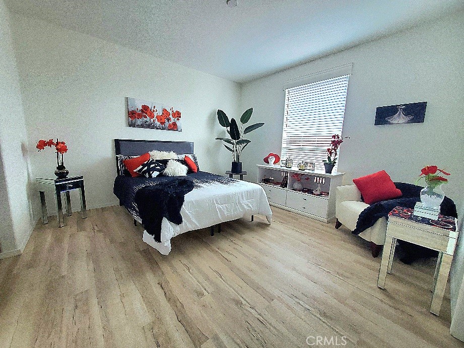 21621 Sandia Road, Unit 150 Apple Valley, CA 92308 - Photo 18 of 45 a bedroom with furniture and a wooden floor