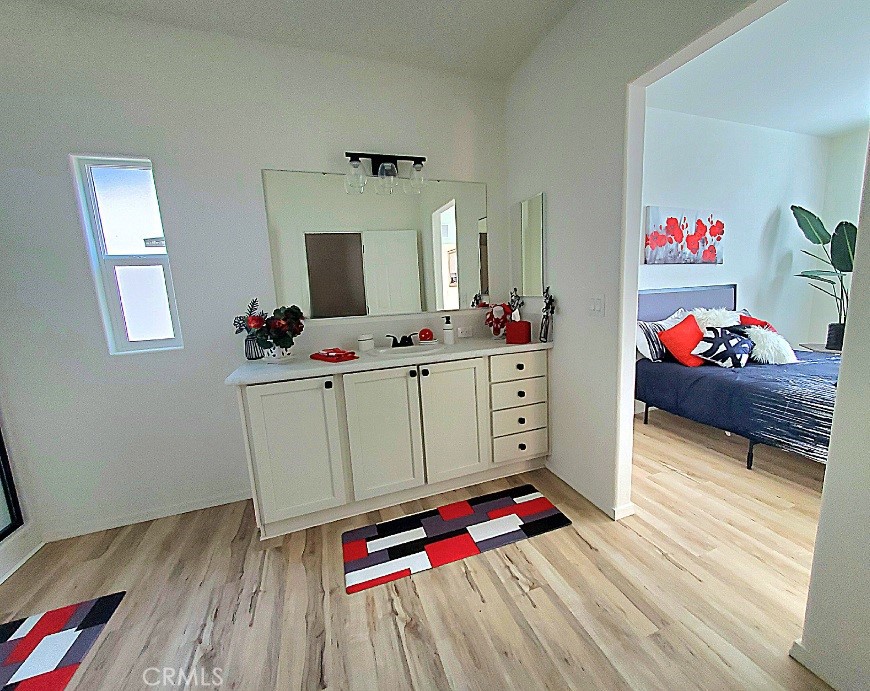 21621 Sandia Road, Unit 150 Apple Valley, CA 92308 - Photo 23 of 45 a hallway with toys and dresser with wooden floor