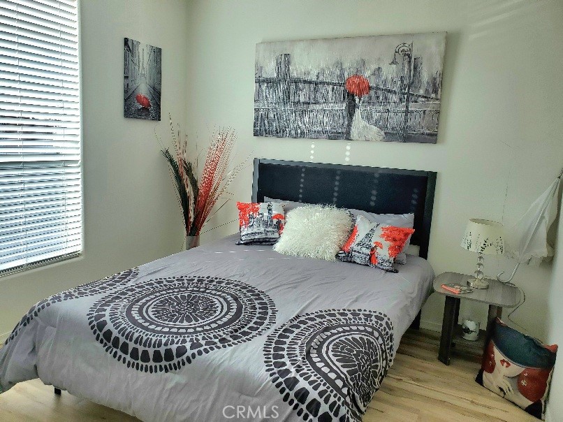 21621 Sandia Road, Unit 150 Apple Valley, CA 92308 - Photo 30 of 45 a bedroom with a bed and a couch