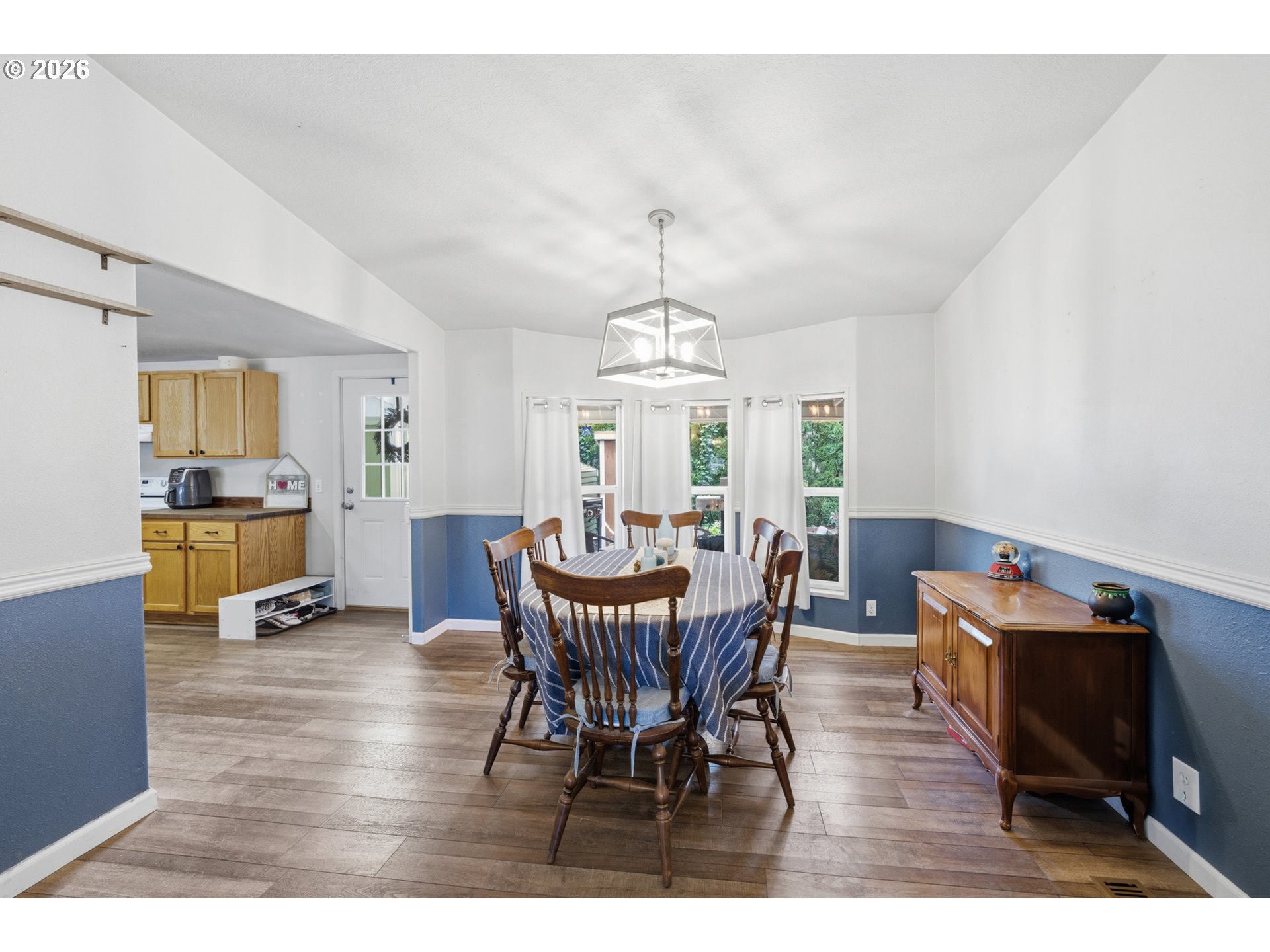 655 Northeast Burnett Road, Unit 91 McMinnville, OR 97128 - Photo 11 of 27 a view of a dining room with furniture and wooden floor