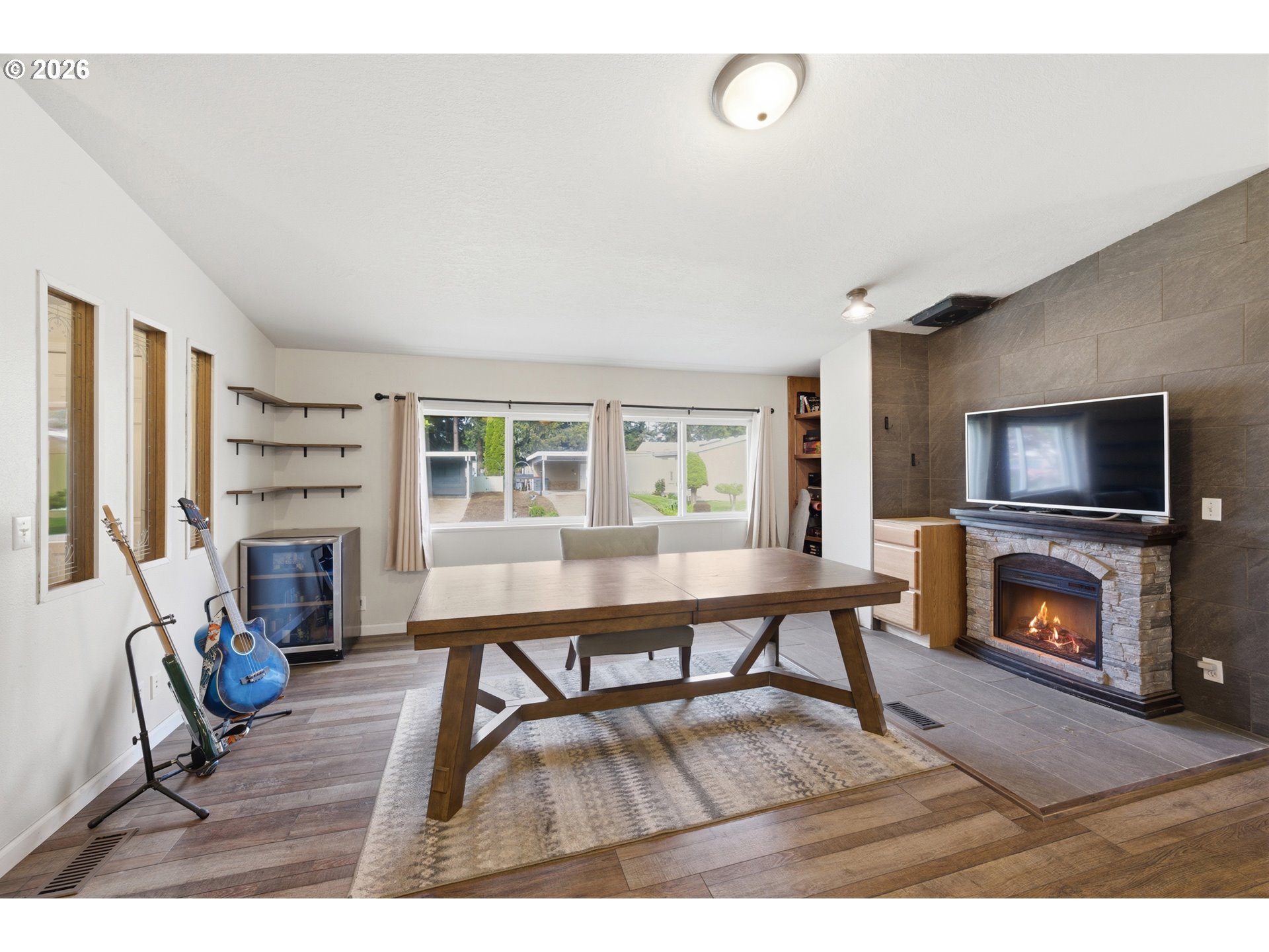 655 Northeast Burnett Road, Unit 91 McMinnville, OR 97128 - Photo 12 of 27 a living room with furniture a flat screen tv and a fireplace