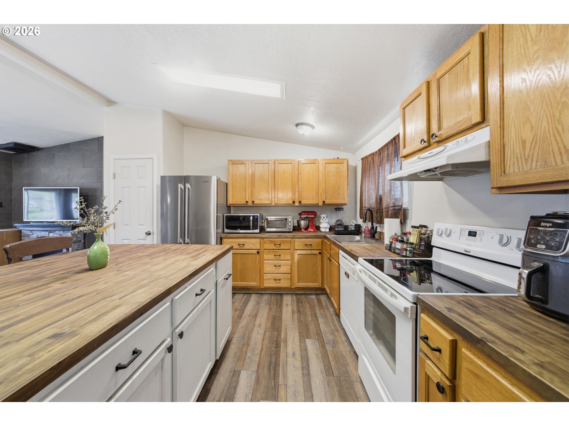 655 Northeast Burnett Road, Unit 91 McMinnville, OR 97128 - Photo 13 of 27 a kitchen with granite countertop a sink stove and cabinets