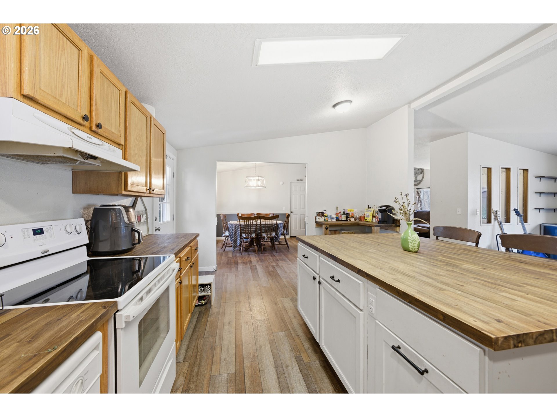 655 Northeast Burnett Road, Unit 91 McMinnville, OR 97128 - Photo 14 of 27 a kitchen with stainless steel appliances granite countertop a sink a stove and a wooden floors