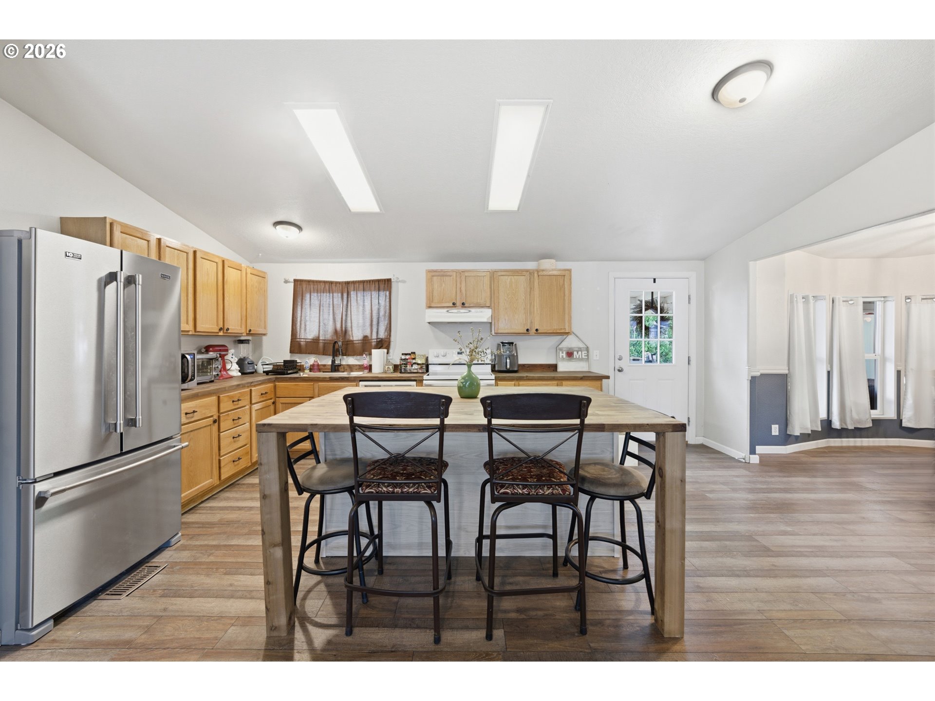 655 Northeast Burnett Road, Unit 91 McMinnville, OR 97128 - Photo 16 of 27 a kitchen with stainless steel appliances kitchen island granite countertop a dining table chairs and granite counter tops