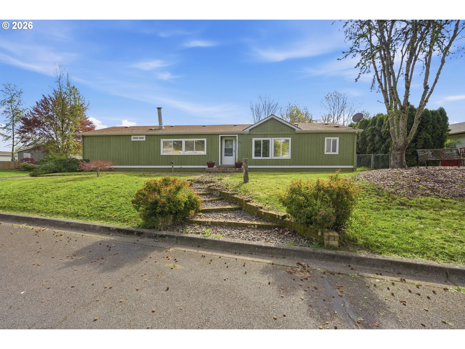 655 Northeast Burnett Road, Unit 91 McMinnville, OR 97128 - Photo 2 of 27 a front view of a house with a yard