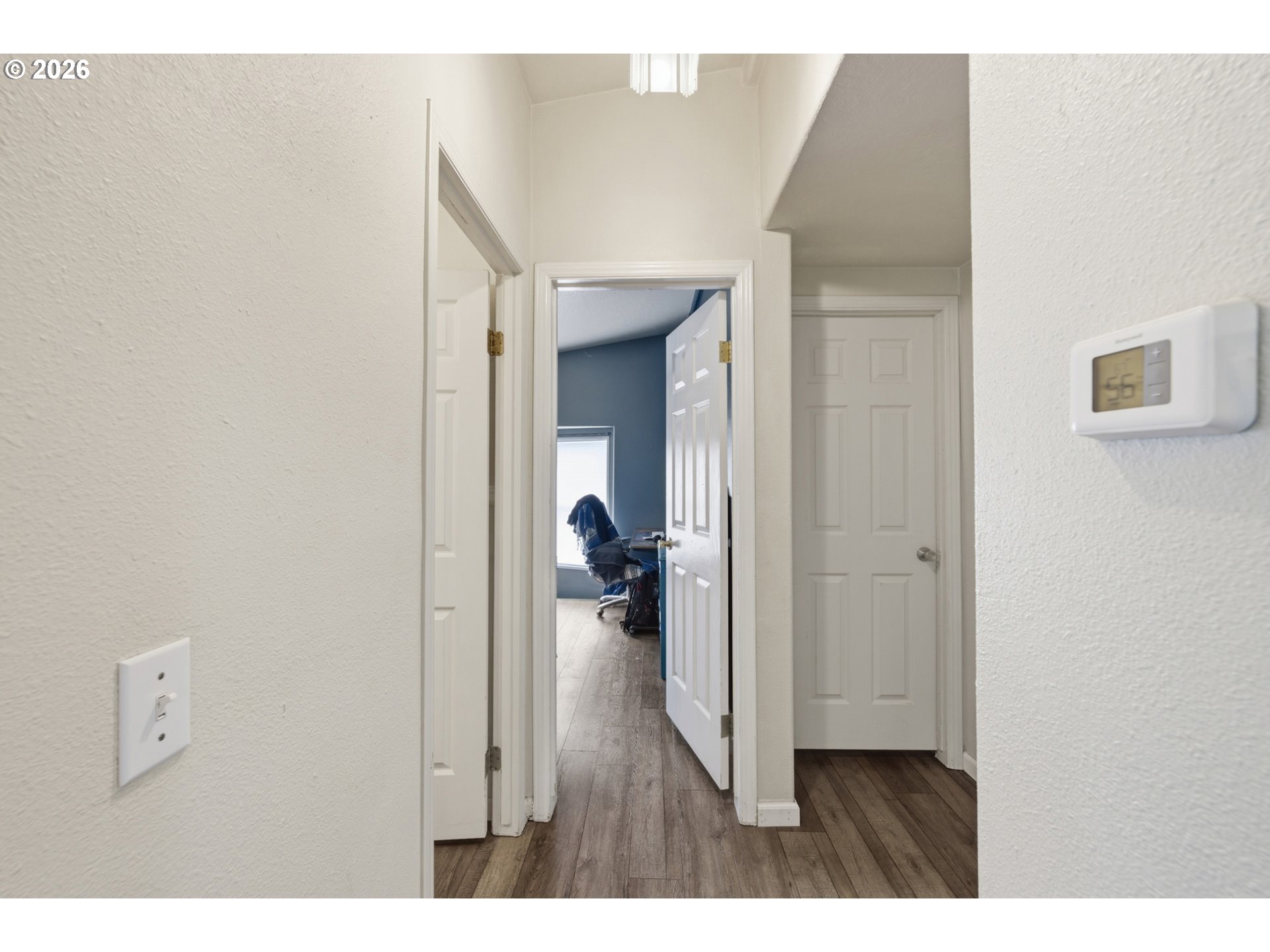 655 Northeast Burnett Road, Unit 91 McMinnville, OR 97128 - Photo 22 of 27 a view of a hallway with wooden floor fireplace and closet