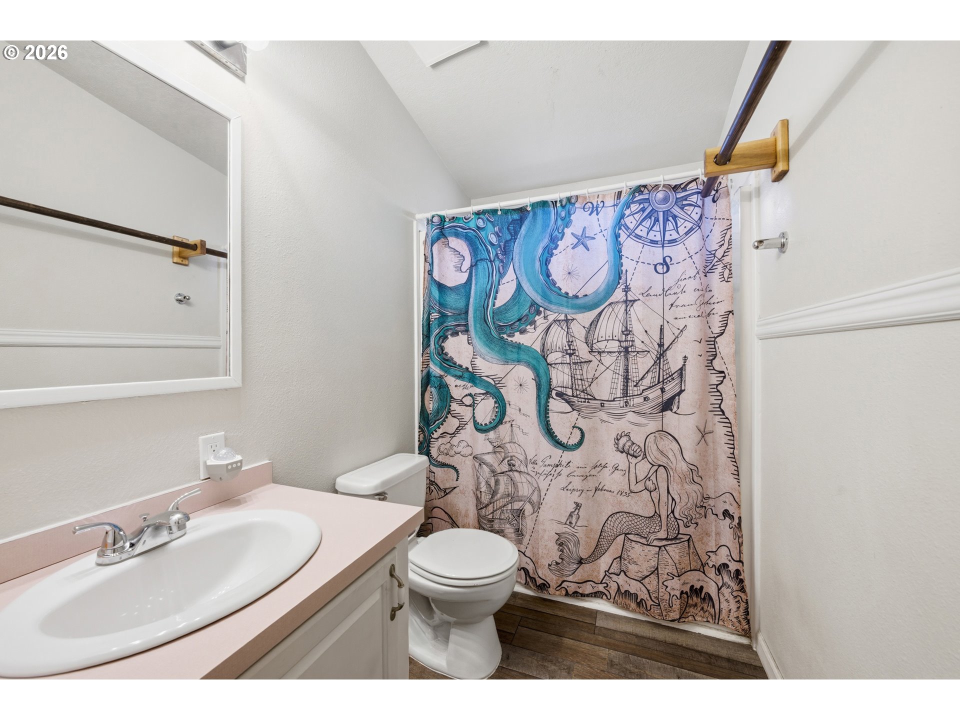 655 Northeast Burnett Road, Unit 91 McMinnville, OR 97128 - Photo 25 of 27 a bathroom with a toilet sink and mirror