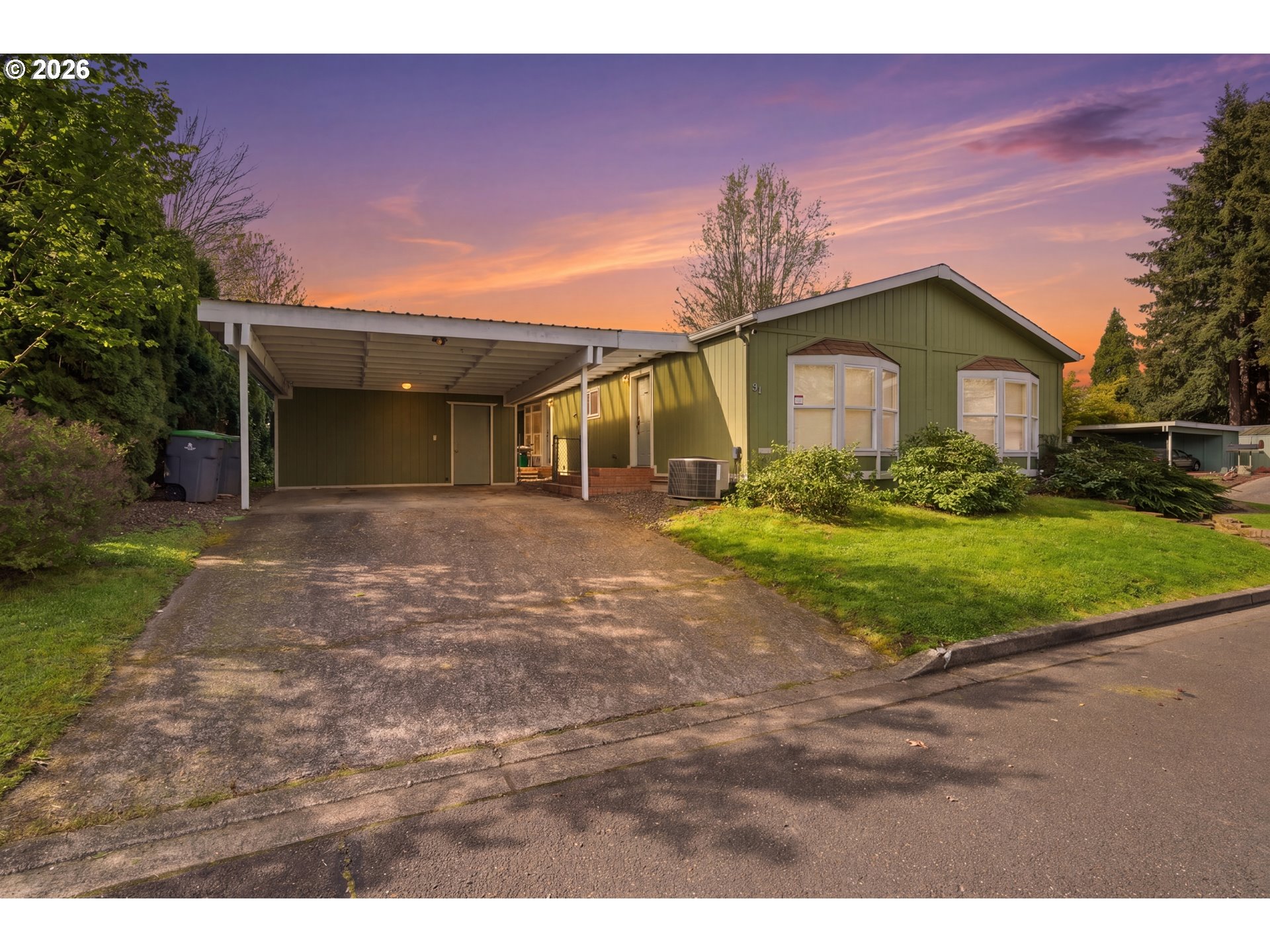 655 Northeast Burnett Road, Unit 91 McMinnville, OR 97128 - Photo 5 of 27 a front view of a house with a yard and garage