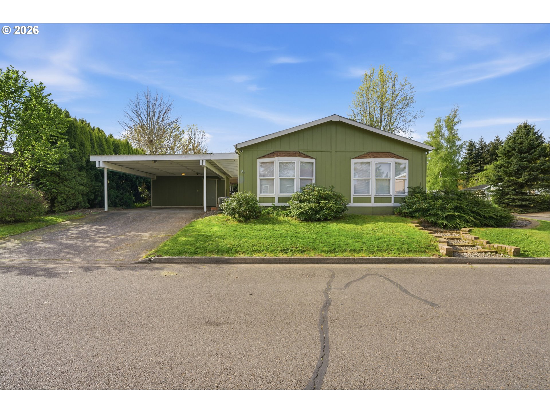 655 Northeast Burnett Road, Unit 91 McMinnville, OR 97128 - Photo 7 of 27 a front view of a house with a yard and garage