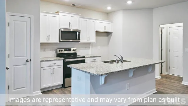 a kitchen with a sink a stove and refrigerator
