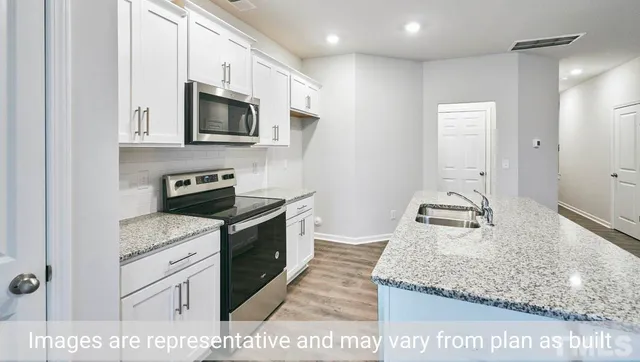 a kitchen with stainless steel appliances granite countertop a sink and a stove
