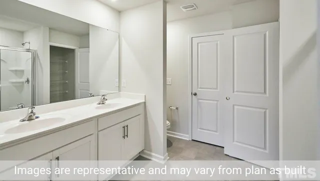 a spacious bathroom with a mirror a vanity and a shower