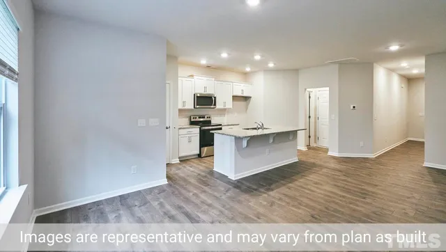 a open kitchen with stainless steel appliances granite countertop a stove top oven a sink and a refrigerator