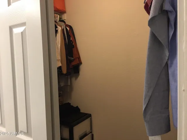 a kitchen with granite countertop white cabinets and stainless steel appliances