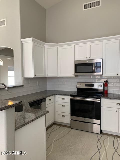 1373 West Kesler Lane Chandler, AZ 85224 - Photo 24 of 25 a kitchen with granite countertop white cabinets and stainless steel appliances