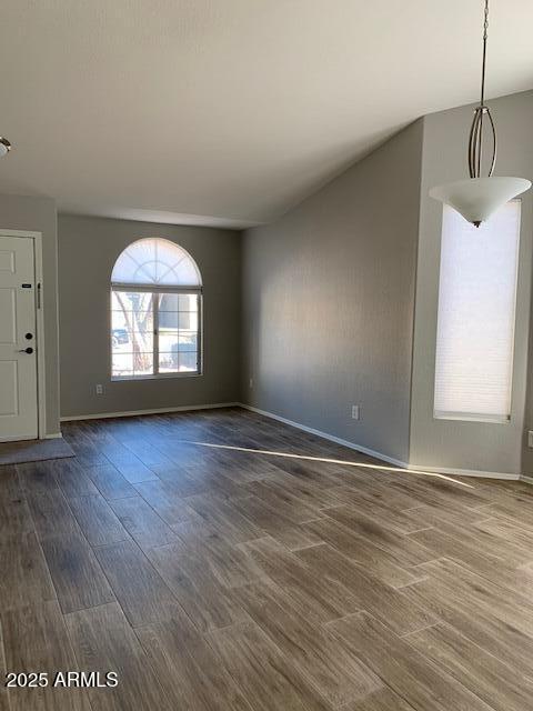 1373 West Kesler Lane Chandler, AZ 85224 - Photo 3 of 25 an empty room with wooden floor and windows