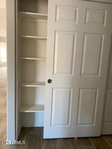 a view of walk in closet with empty room