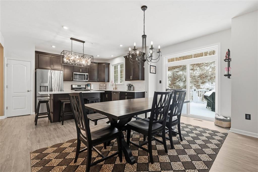 155 Craig Street Imperial, PA 15126 - Photo 13 of 39 a view of a dining room and livingroom with furniture wooden floor a chandelier