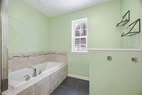 a bathroom with a sink a toilet a mirror and shower curtain