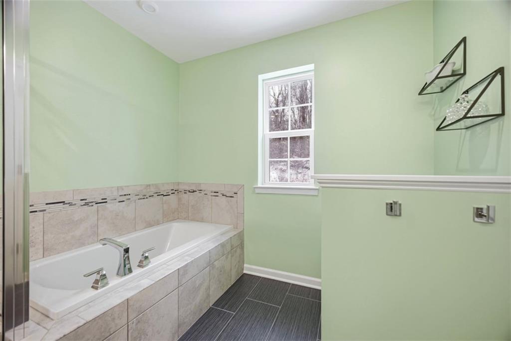 155 Craig Street Imperial, PA 15126 - Photo 26 of 39 a bathroom with a tub and a shower