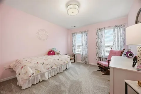 a bedroom with a bed and a dresser in it