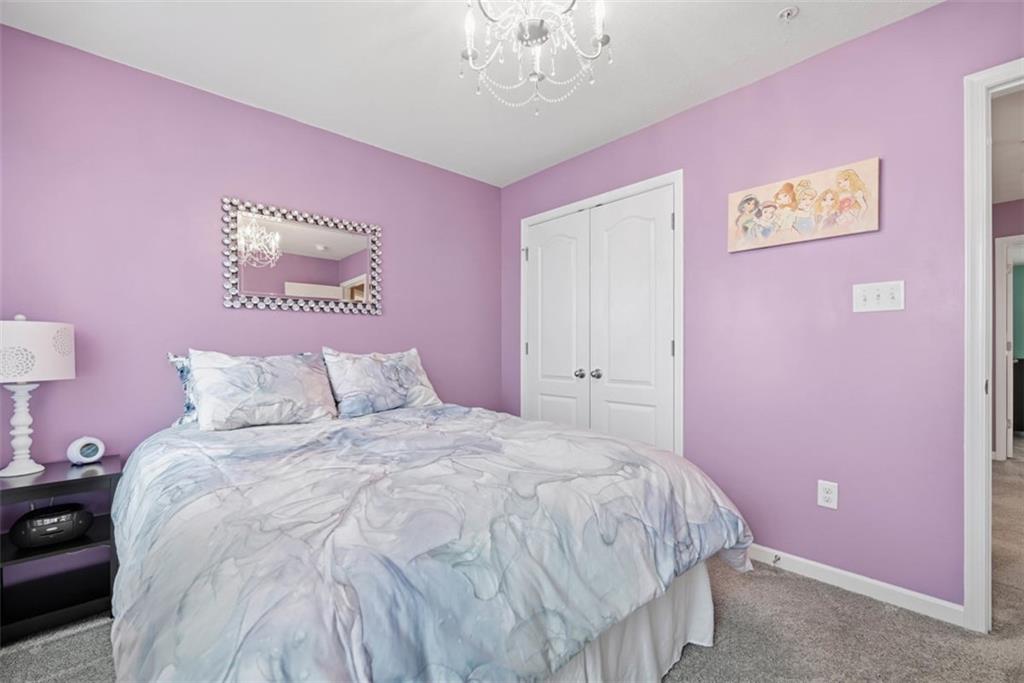 155 Craig Street Imperial, PA 15126 - Photo 31 of 39 a large bed room with a bed and a chandelier