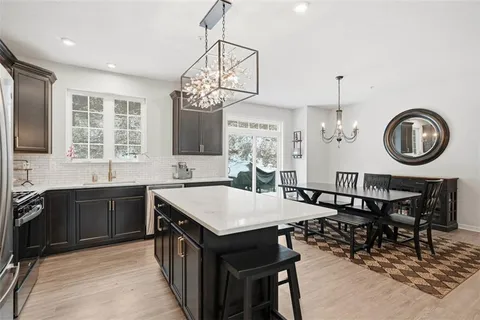 a kitchen with stainless steel appliances a sink stove top oven and cabinets