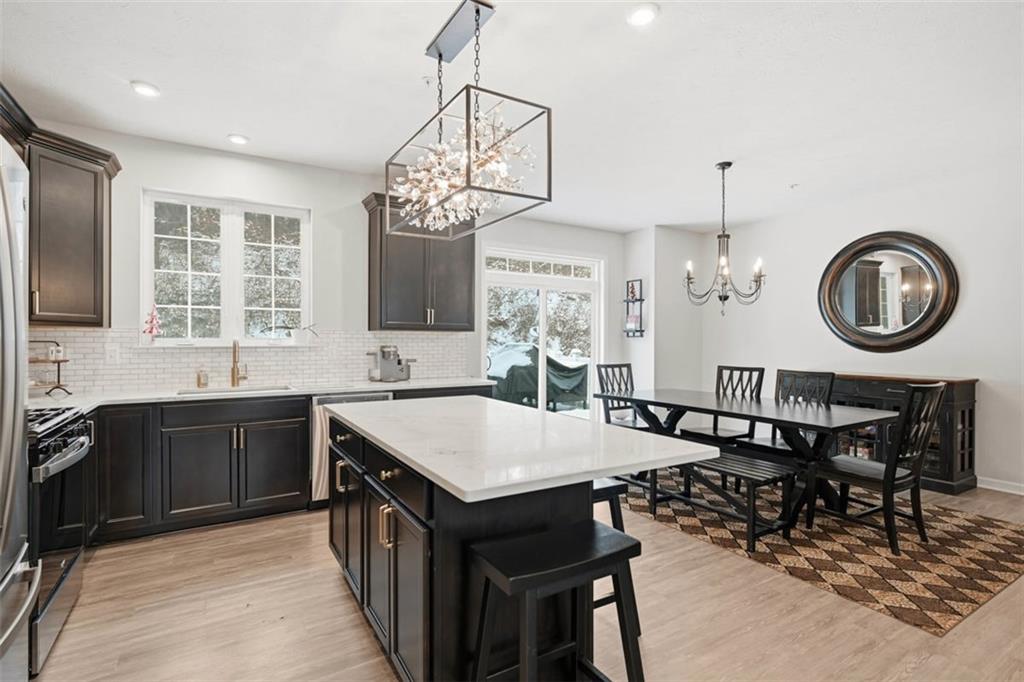 155 Craig Street Imperial, PA 15126 - Photo 7 of 39 a kitchen with a table chairs a stove a dining table and a chandelier