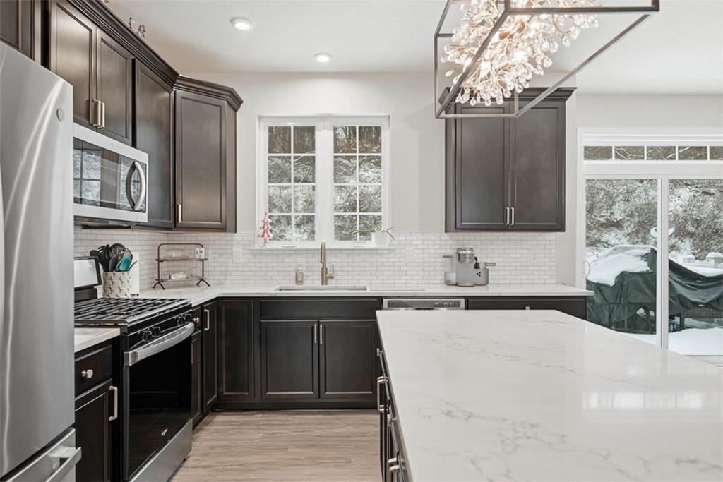 155 Craig Street Imperial, PA 15126 - Photo 8 of 39 a kitchen with stainless steel appliances a sink stove top oven and cabinets