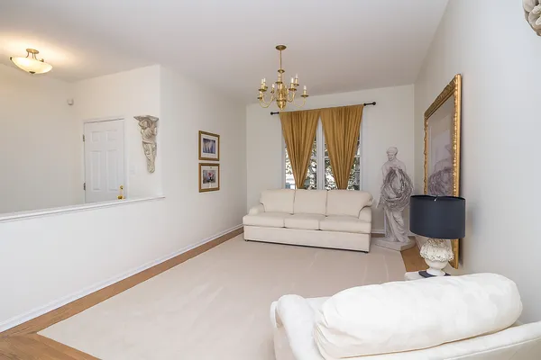 a living room with furniture a dining table and chairs with wooden floor