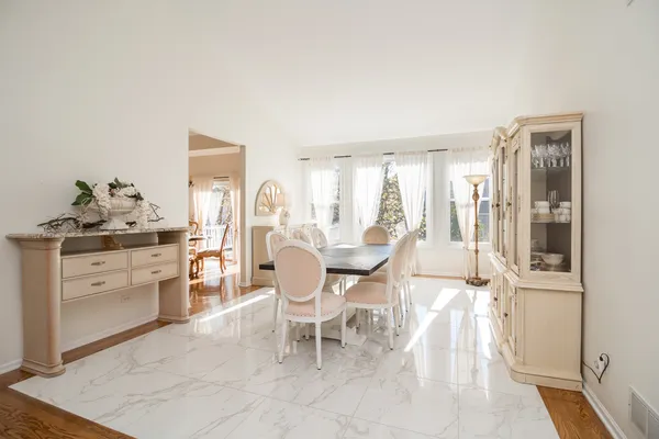 a kitchen with stainless steel appliances white cabinets and a wooden floor