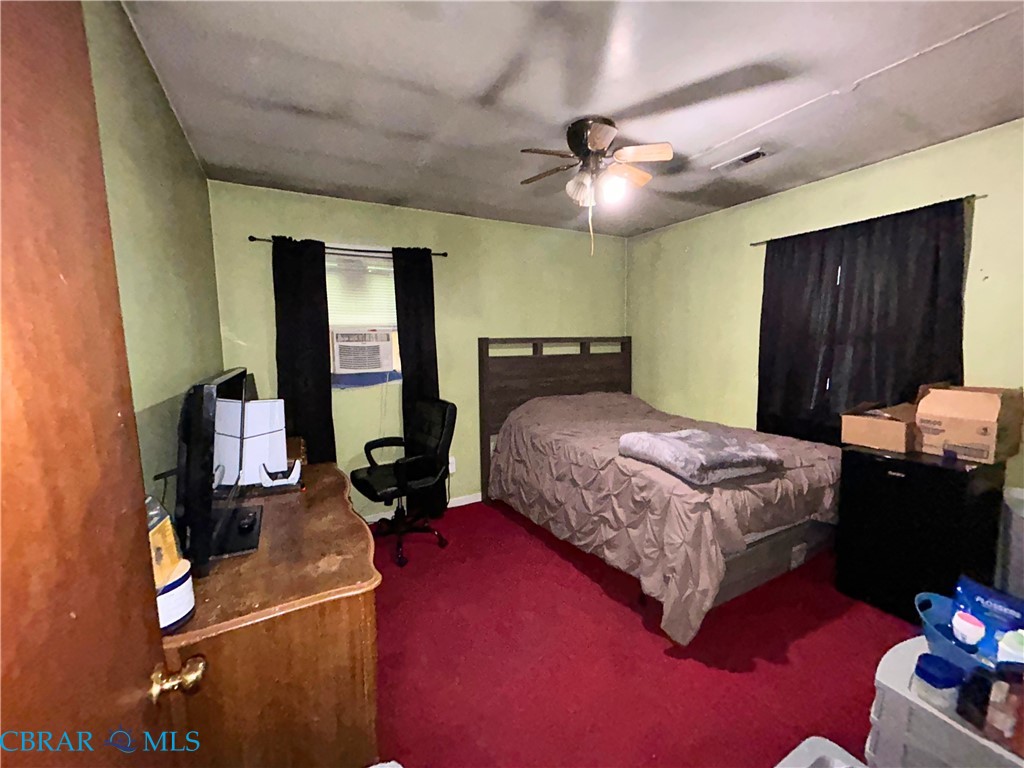 449 Gaskins Road Weems, VA 22576 - Photo 4 of 10 a bedroom with a bed and wooden floor