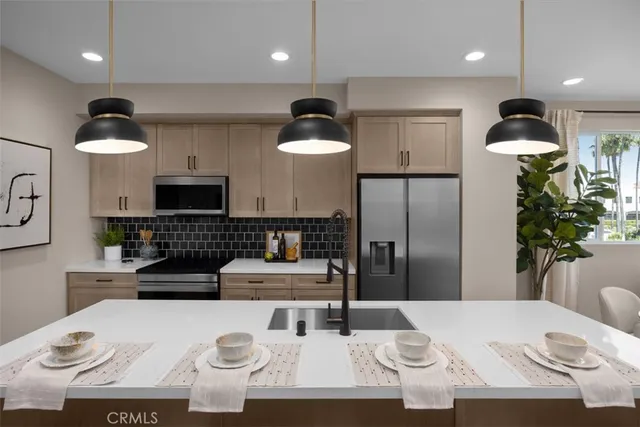 a kitchen with a refrigerator a stove a dining table and chairs with wooden floor