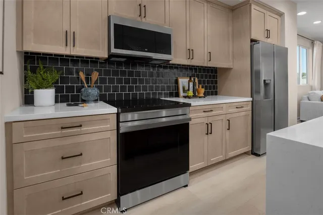 a kitchen with a stove microwave and refrigerator