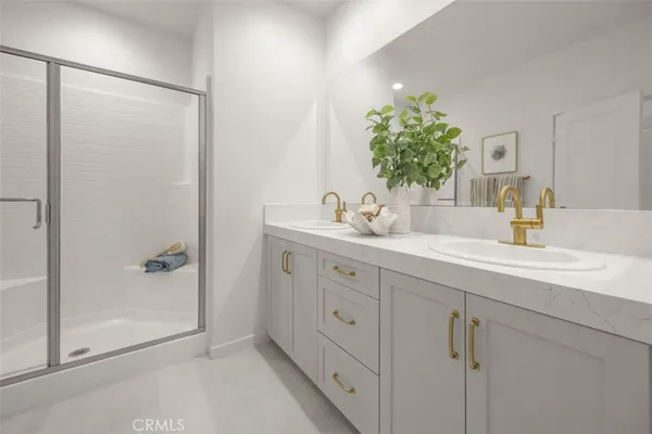 a bathroom with a shower sink and mirror