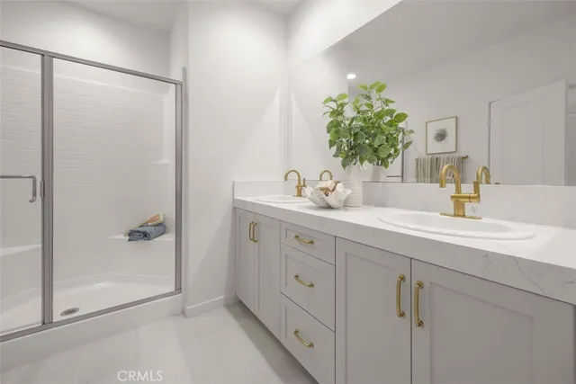 a bathroom with a shower sink and mirror