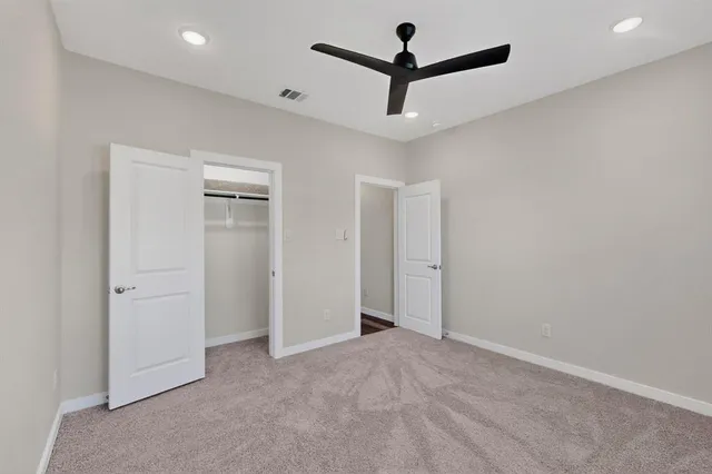 an empty room with ceiling fan
