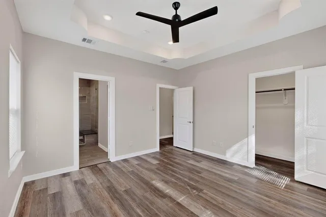a view of a room with wooden floor and white walls